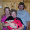 Photo of 8 weeks old Becky, with new family; Cory, Cindy and Steve.