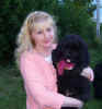Photo of Newfoundland puppy Abby, at  8 weeks, with new owner Bonnie.